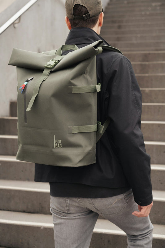 A man walking up some stairs with a backpack on his back